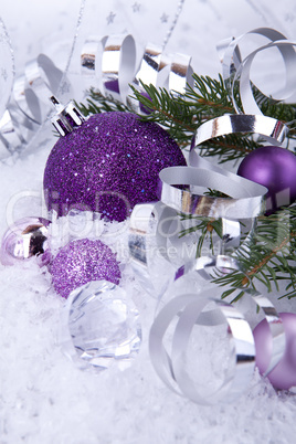 beautiful christmas decoration in purple and silver on white snow