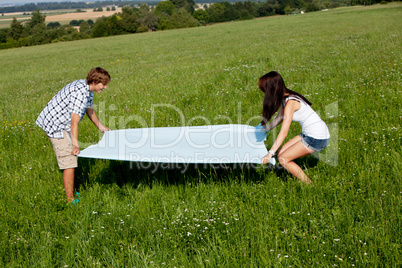 young couple outdoor in summer on blanket in love