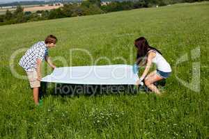 young couple outdoor in summer on blanket in love