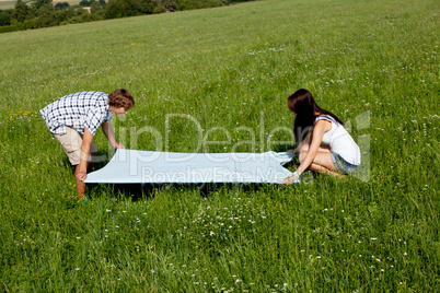 young couple outdoor in summer on blanket in love