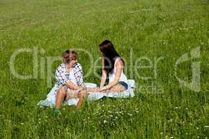 young couple outdoor in summer on blanket in love