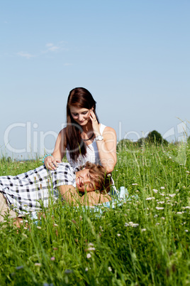 young couple outdoor in summer on blanket in love