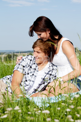 young couple outdoor in summer on blanket in love