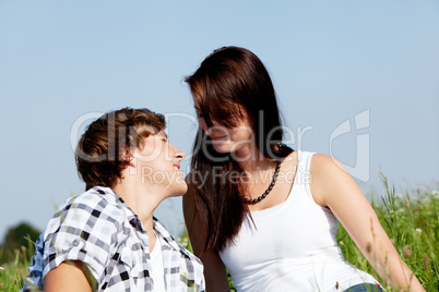 young couple outdoor in summer on blanket in love