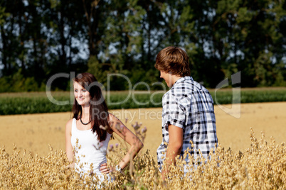 happy couple in love outdoor in summer on field