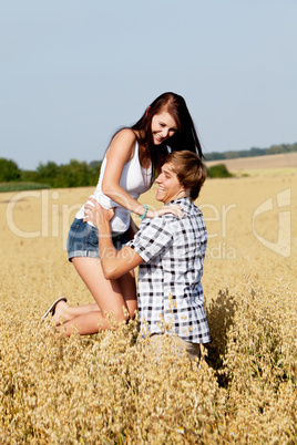 happy couple in love outdoor in summer on field