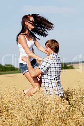 happy couple in love outdoor in summer on field