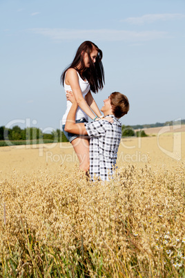 happy couple in love outdoor in summer on field