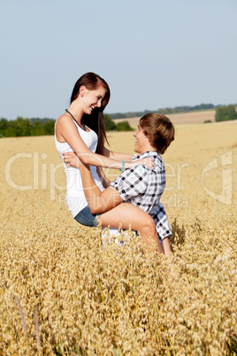 happy couple in love outdoor in summer on field