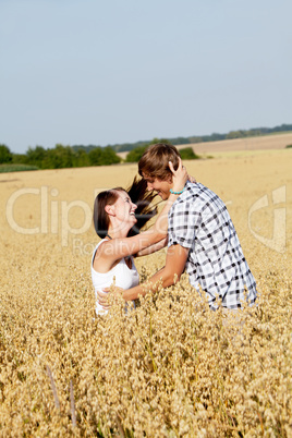 happy couple in love outdoor in summer on field