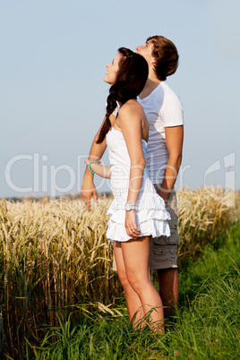 happy couple in love outdoor in summer on field