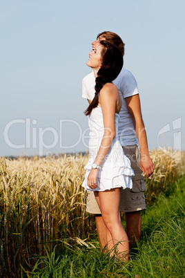 happy couple in love outdoor in summer on field