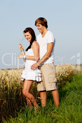 happy couple in love outdoor in summer on field