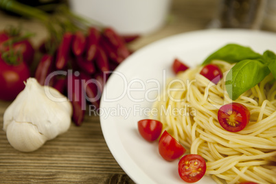 fresh tasty pasta with tomato and basil on table