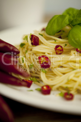 fresh pasta with basil and red chilli on table