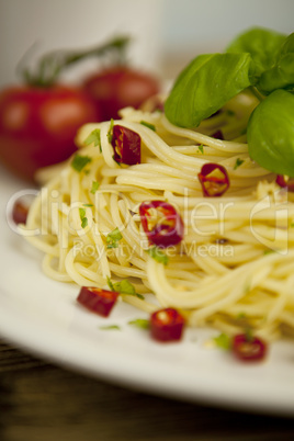 fresh pasta with basil and red chilli on table