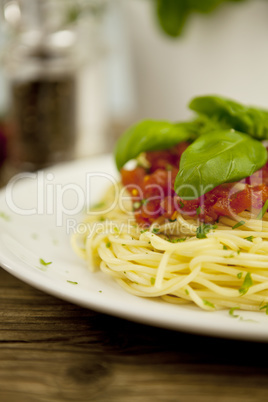 delicious fresh spaghetti with tomato sauce and parmesan on table