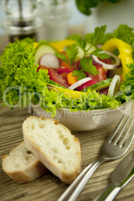 fresh tasty healthy mixed salad and bread on table