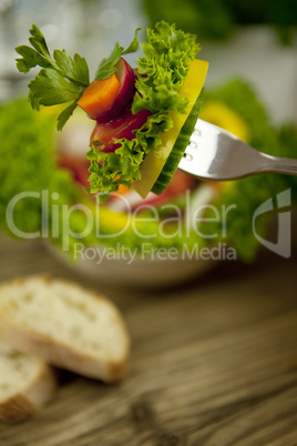 fresh tasty healthy mixed salad and bread on table