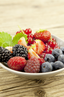 fresh tasty berry collection on table in summer