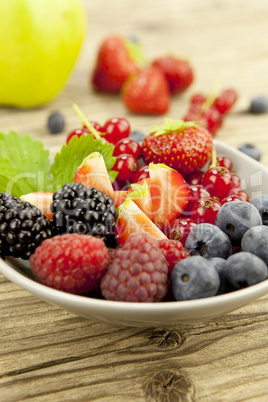 fresh tasty berry collection on table in summer