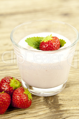 fresh tasty strawberry yoghurt shake dessert on table