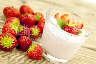 fresh tasty strawberry yoghurt shake dessert on table