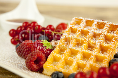 fresh tasty waffer with powder sugar and mixed fruits