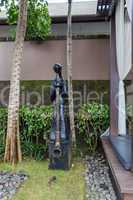 Ornate column in formal Balinese garden