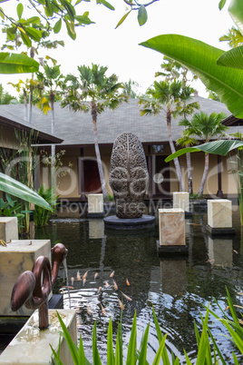 Ornate column in formal Balinese garden