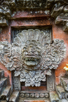 Ornate column in formal Balinese garden