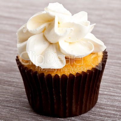 tasty sweet homemade cupcakes with cream on table