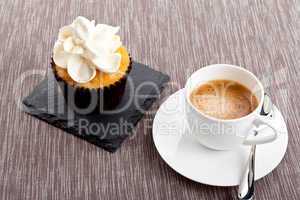 tasty sweet cupcake and hot aromatic espresso coffee