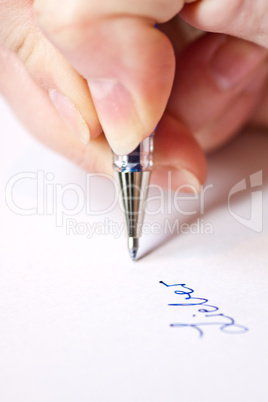 womans hand is writing a letter with a pen