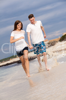 happy young couple on the beach in summer holiday love