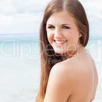 smiling young brunette woman in summer on the beach
