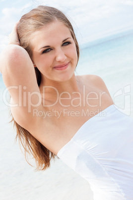 smiling young brunette woman in summer on the beach