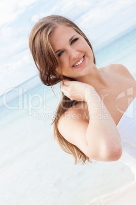 smiling young brunette woman in summer on the beach