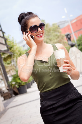 attractive young woman with smartphone and sunglasses outdoor