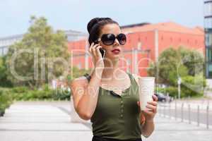 attractive young woman with smartphone and sunglasses outdoor