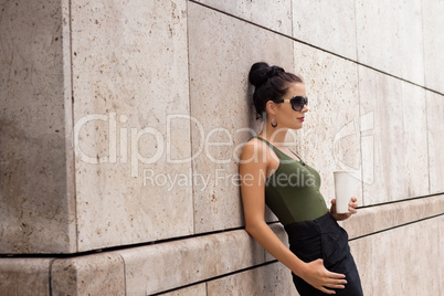 attractive young woman with smartphone and sunglasses outdoor