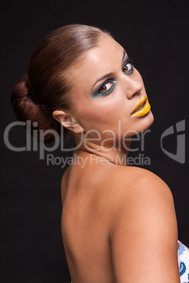 woman with extreme colorfull make up in blue and yellow