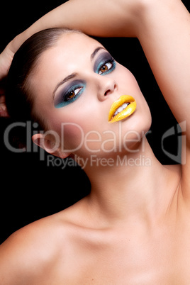 woman with extreme colorfull make up in blue and yellow