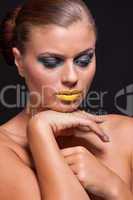 woman with extreme colorfull make up in blue and yellow