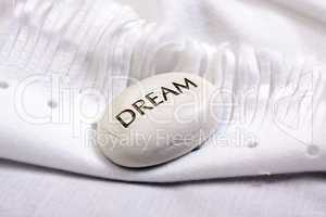 white dream stone on a white blanket