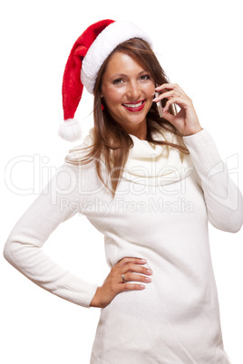 Pretty woman in a Santa hat reading an sms
