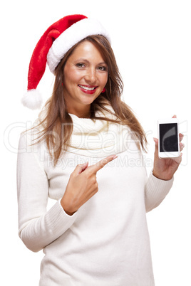 Pretty woman in a Santa hat reading an sms