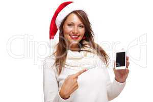 Pretty woman in a Santa hat reading an sms