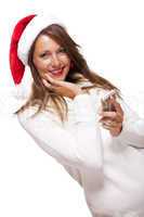 Pretty woman in a Santa hat reading an sms