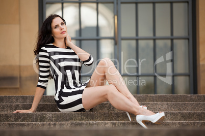 beautiful woman in sexy dress on stairs summertime